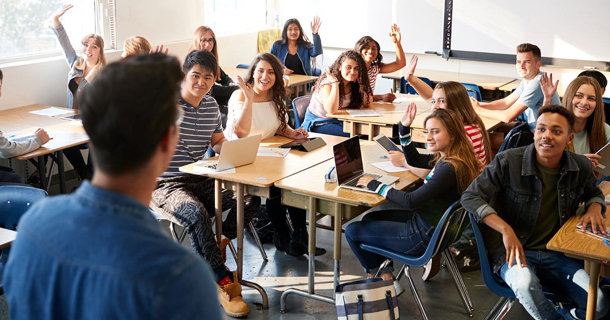 High school students raising hands